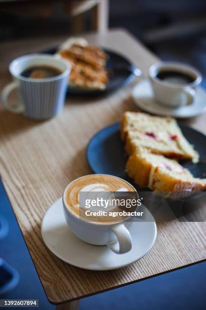 coffee cups and cakes on table - enjoying coffee cafe morning light stock pictures, royalty-free photos & images