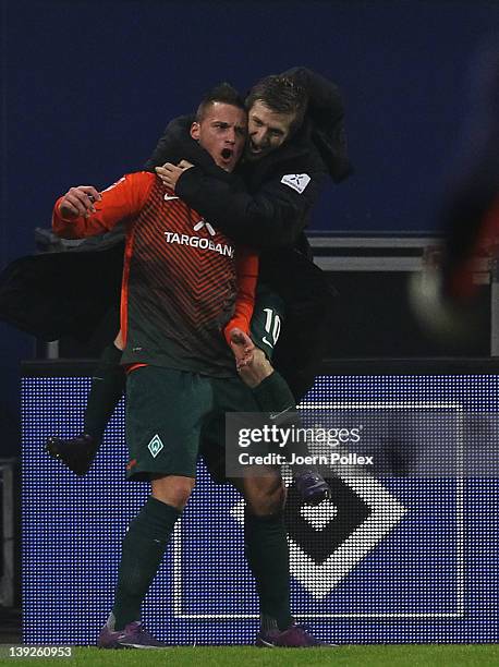 Marko Arnautovic of Bremen celebrates with his team mate Marko Marin after scoring his team's third goal during the Bundesliga match between...