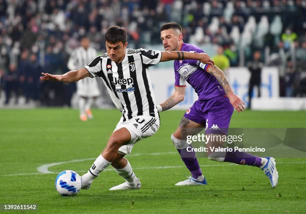 Paulo Dybala of Juventus battles for possession with Cristiano Biraghi of Fiorentina during the Coppa Italia Semi Final 2nd Leg match between...