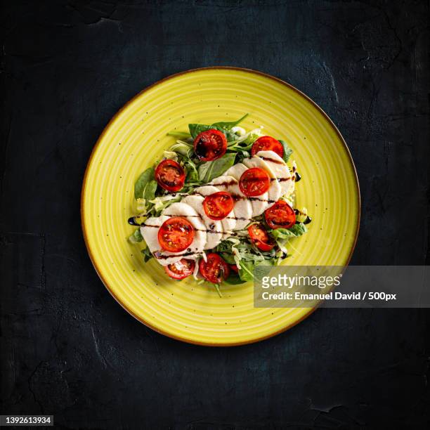 delicious caprese salad,directly above shot of pasta in plate on table - caprese stock-fotos und bilder