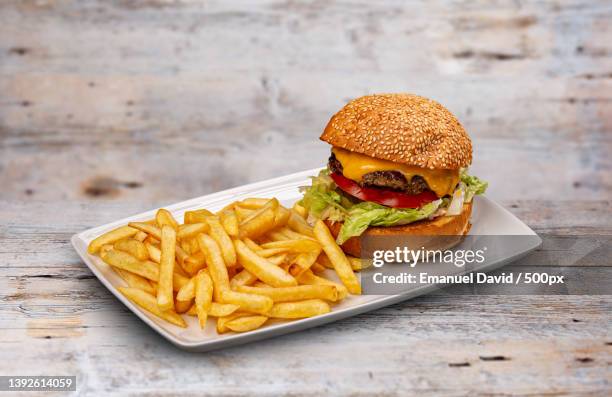 fresh tasty burger,close-up of burger and french fries on table - burger close up stock pictures, royalty-free photos & images