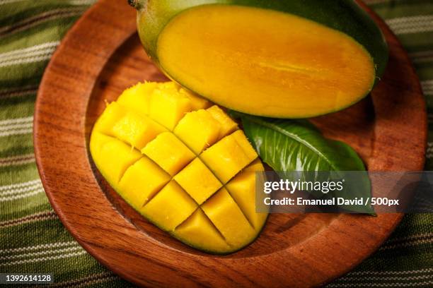 delicious ripe mango fruit with leaf and mango cube - マンゴー ストックフォトと画像