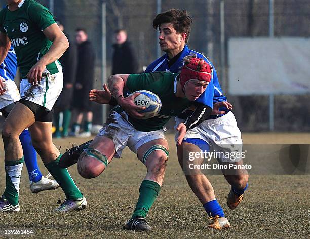 Joe Bercis of Ireland U18 is challenged by Bruno Lorenzo of Italy U18 during the U18 rugby test match between Italy U18 and Ireland U18 on February...