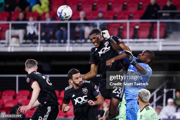 Donovan Pines of D.C. United heads the ball as Bill Hamid attempts a punching save against Austin FC during the second half of the MLS game at Audi...