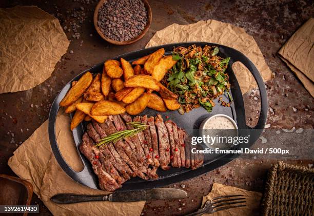 gilled beef steak,directly above shot of meat on table - strip steak stock pictures, royalty-free photos & images