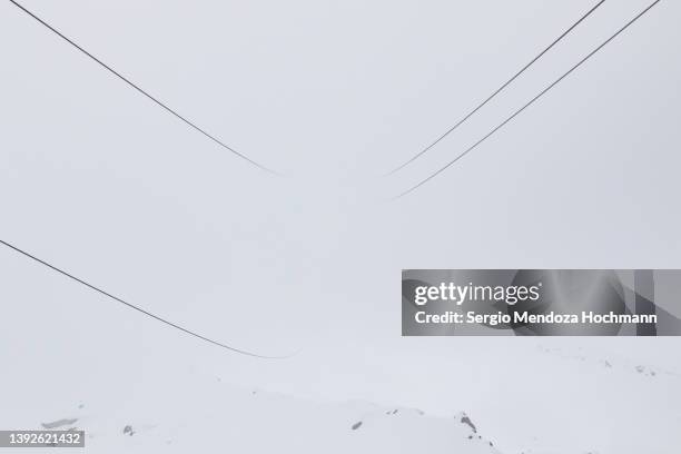 cable car wire rope heading into the unknown in beautiful, snowy french alps - chamonix, france - wire rope stock pictures, royalty-free photos & images