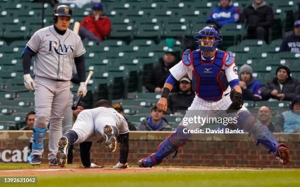 Randy Arozarena of the Tampa Bay Rays is safe at home plate as Yan Gomes of the Chicago Cubs waits for a throw during the first inning at Wrigley...