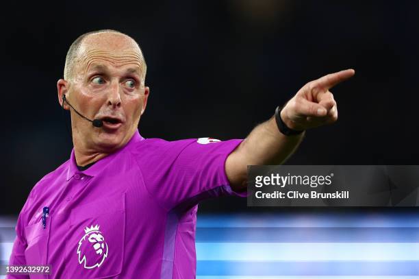 Referee Mike Dean during the Premier League match between Manchester City and Brighton & Hove Albion at Etihad Stadium on April 20, 2022 in...