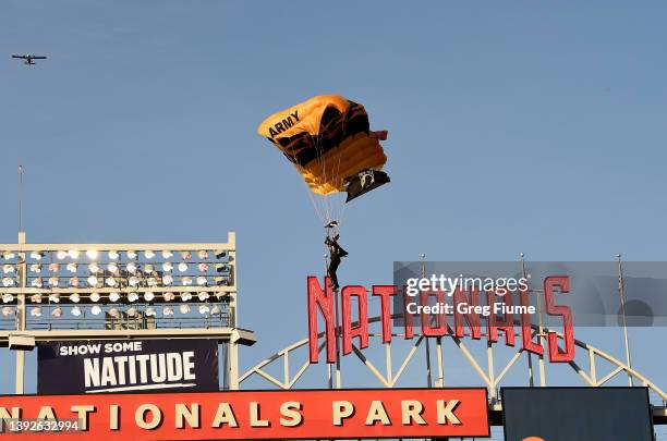 Member of the US Army Parachute Team The Golden Knights lands at Nationals Park before the game between the Washington Nationals and the Arizona...