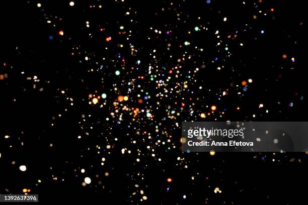 many shiny colorful confetti falling on black background. new year backdrop for your design. three dimensional illustration - confetti explosion stock-fotos und bilder