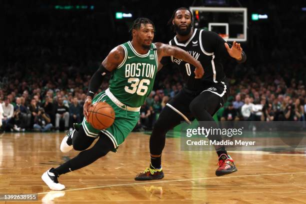 Marcus Smart of the Boston Celtics drives down court against Andre Drummond of the Brooklyn Nets during the second quarter of Game Two of the Eastern...