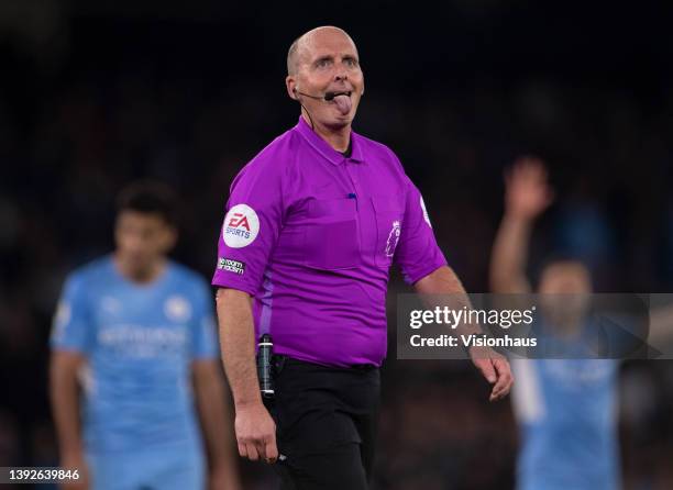 Referee Mike Dean during the Premier League match between Manchester City and Brighton & Hove Albion at Etihad Stadium on April 20, 2022 in...