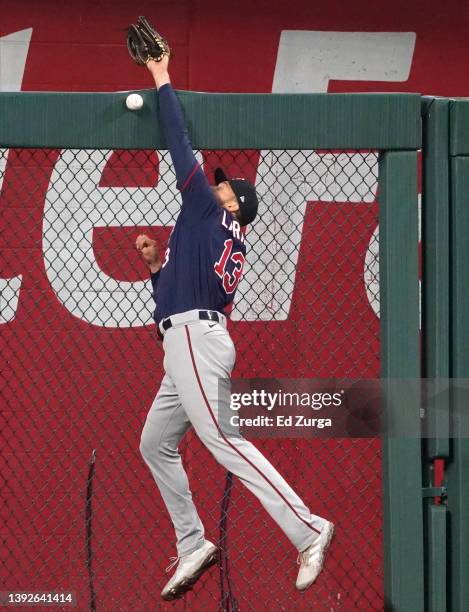 Trevor Larnach of the Minnesota Twins reaches out but can't catch a ball off the bat of Whit Merrifield of the Kansas City Royals in the first inning...