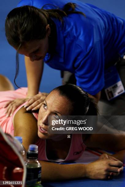 Serbian tennis player Jelena Jankovic receives treatment from a trainer during her womens singles match against Russian opponent Maria Sharapova in...