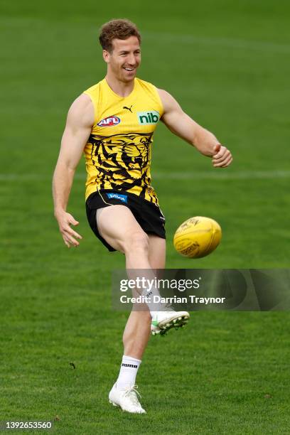 Kane Lambert of the Tigers kicks the ball during a Richmond Tigers AFL training session at Punt Road Oval on April 21, 2022 in Melbourne, Australia.