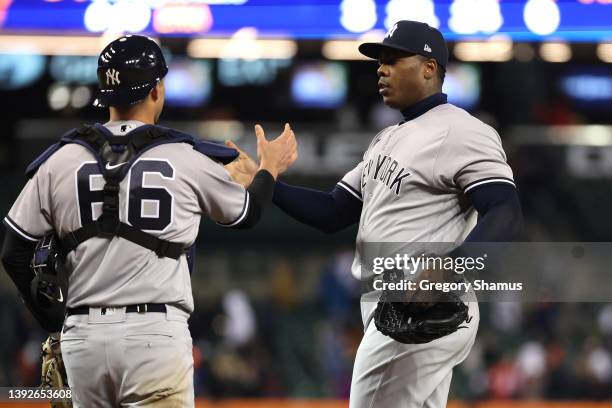 Aroldis Chapman of the New York Yankees celebrates a 5-3 win over the Detroit Tigers with Kyle Higashioka at Comerica Park on April 20, 2022 in...