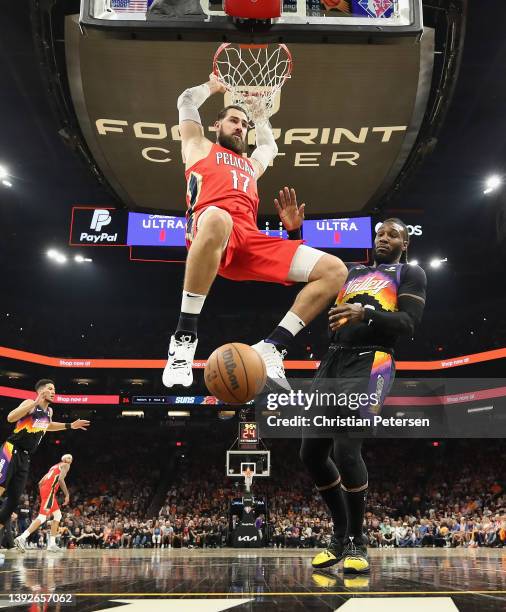 Jonas Valanciunas of the New Orleans Pelicans slam dunks the ball against Jae Crowder of the Phoenix Suns during the second half of Game One of the...