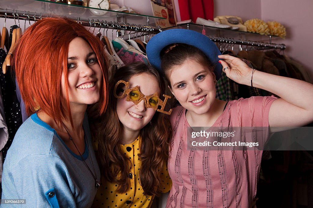 Young women dressed in costumes in clothes shop, portrait