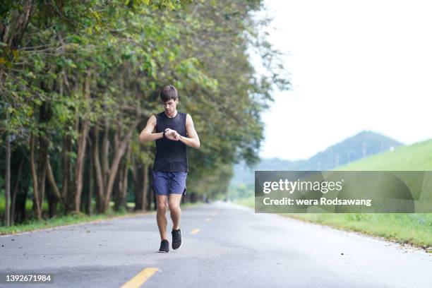 sportsman training for running wear fitness tracker watches for count steps - counting stock pictures, royalty-free photos & images