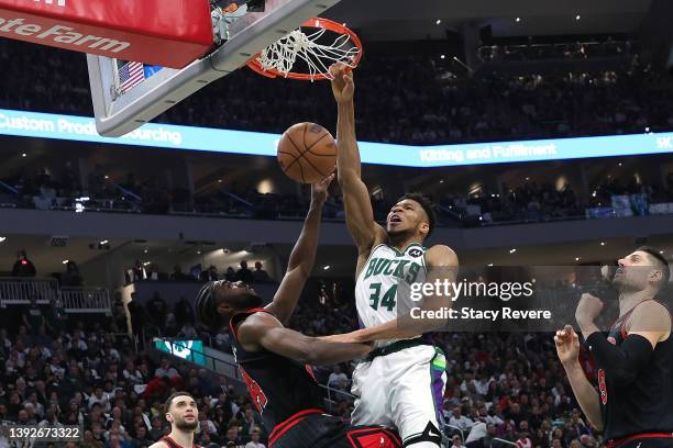 Giannis Antetokounmpo of the Milwaukee Bucks dunks over Patrick Williams of the Chicago Bulls during the second half of Game Two of the Eastern...