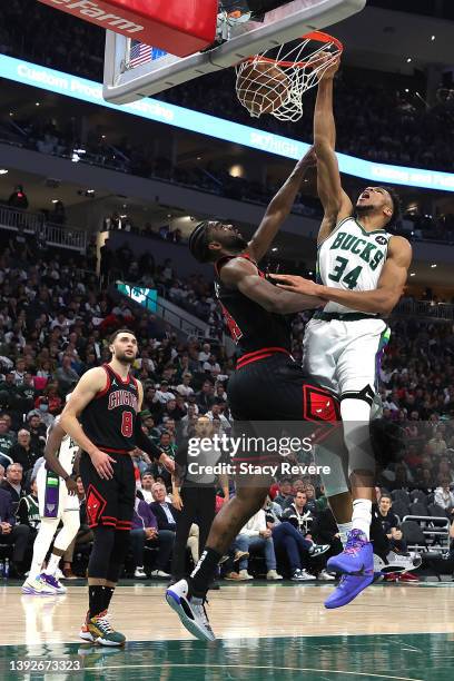 Giannis Antetokounmpo of the Milwaukee Bucks dunks over Patrick Williams of the Chicago Bulls during the second half of Game Two of the Eastern...