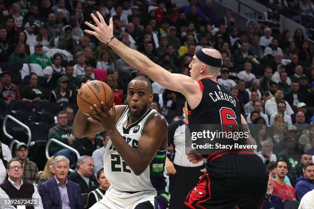 Khris Middleton of the Milwaukee Bucks is defended by Alex Caruso of the Chicago Bulls in the second half of Game Two of the Eastern Conference First...