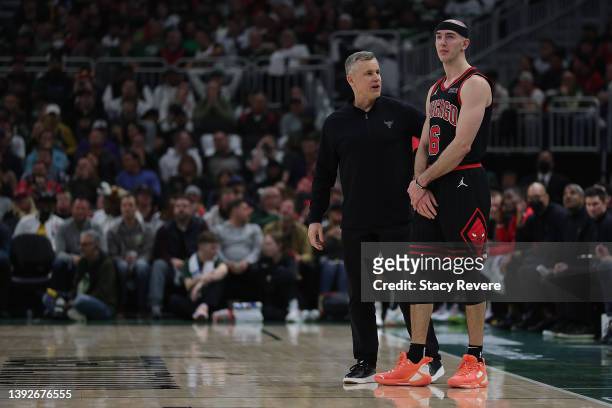 Head coach Billy Donovan of the Chicago Bulls speaks with Alex Caruso during Game Two of the Eastern Conference First Round Playoffs against the...