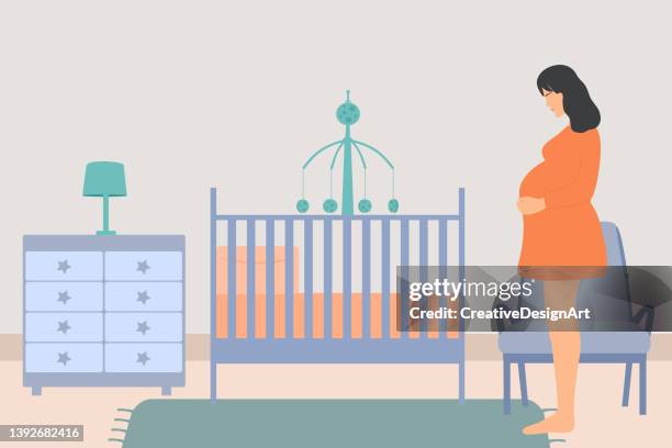 side view of young pregnant woman waiting for baby in baby room - hanging mobile stock illustrations