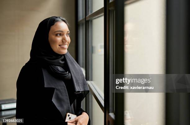 portrait of early 20s saudi businesswoman - saudi telecom stock pictures, royalty-free photos & images