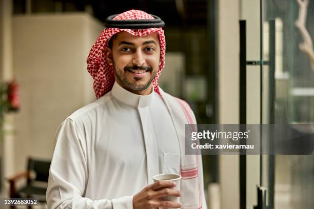 candid office portrait of young saudi businessman - saudi arabien bildbanksfoton och bilder