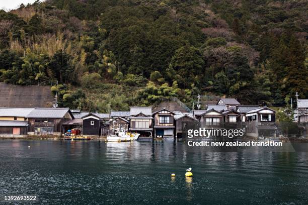 overcast day at ine no funaya (traditional boathouse of ine) in winter, japan - new zealand houses stock-fotos und bilder