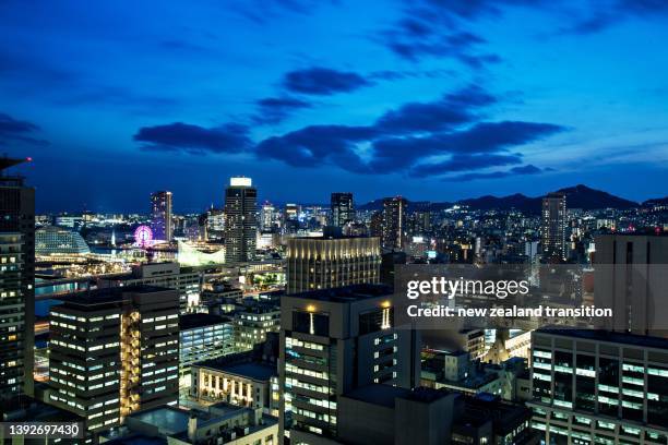 high angle view of kobe port area in blue hour, japan - kobe japan stock-fotos und bilder