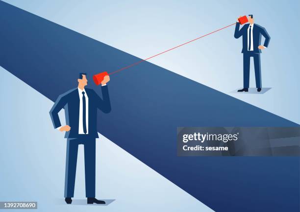 two businessmen use tin can phone to communicate and communicate across a ravine, solve the problem of distance in communication. - man talking to camera stock illustrations