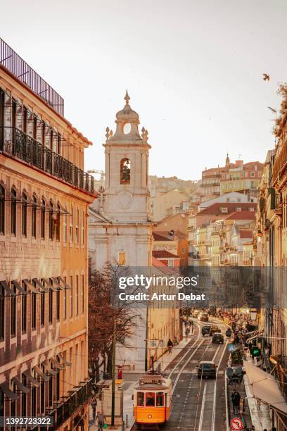 idyllic view of chiado quarter in lisbon with the yellow famous tram railway. - lissabon stock-fotos und bilder