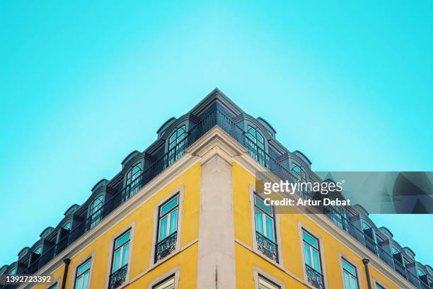 building architecture with yellow façade in lisbon. - baixa stock pictures, royalty-free photos & images