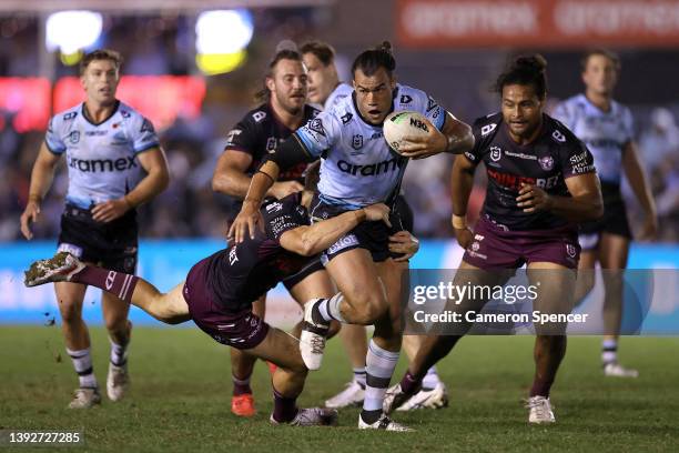 Toby Rudolf of the Sharks is tackled during the round seven NRL match between the Cronulla Sharks and the Manly Sea Eagles at PointsBet Stadium on...