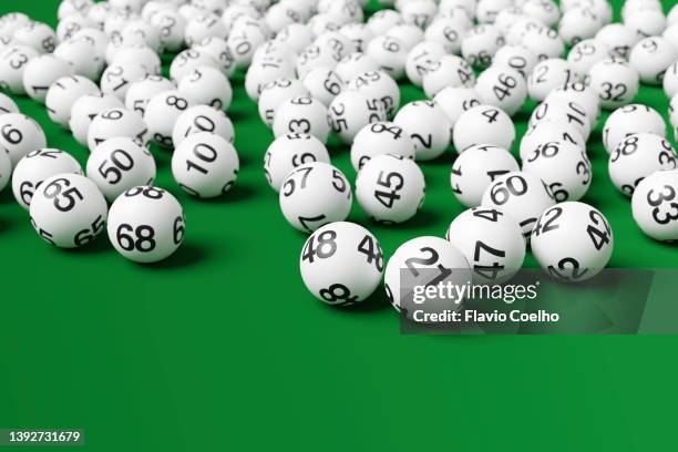 lottery balls on green surface - lottery balls stock-fotos und bilder