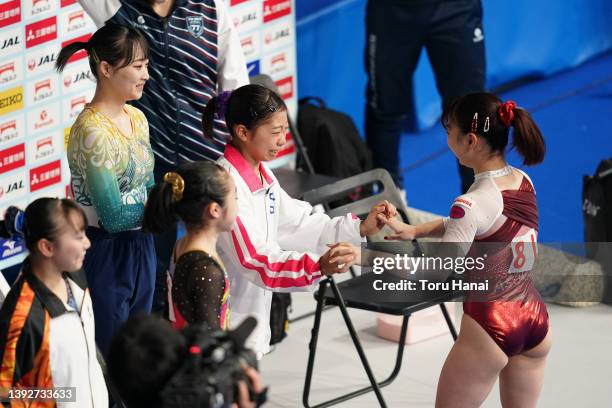 Asuka Teramoto reacts with Urara Ashikawa and Yuna Hiraiwa after competing on the balance beam during day one of the 76th Japan Artistic Gymnastics...