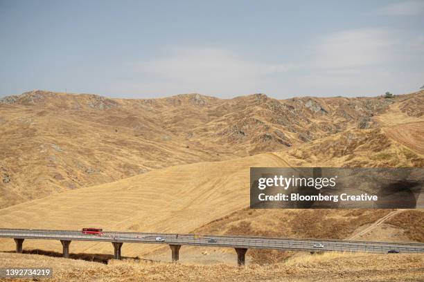 hillside soil erosion by a highway - mezzogiorno stock-fotos und bilder