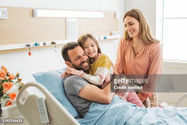 visiting father in hospital - girl in hospital bed sick stock pictures, royalty-free photos & images
