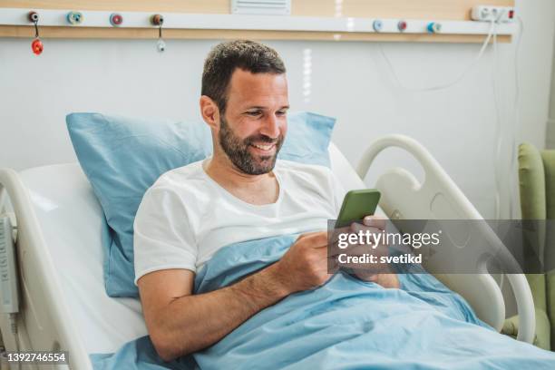 young man in hospital bed. - paramedic phone stock pictures, royalty-free photos & images
