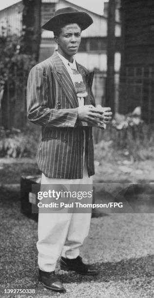 Jamaican-born Mr W 'William' Dickson, wearing a 'zoot suit' as he steps ashore after arriving onboard the Empire Windrush, at the Port of Tilbury, on...