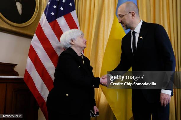 Treasury Secretary Janet Yellen and Ukraine Prime Minister Denys Shmyhal shake hands before a meeting at the Treasury Department on April 21, 2022 in...