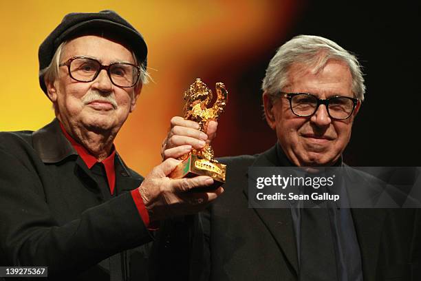 Italian directors Vittorio and Paolo Taviani celebrate after receiving the Golden Bear prize awarded for their film 'Caesar Must Die' the Closing...