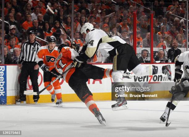 Brooks Orpik of the Pittsburgh Penguins hits Andrej Meszaros of the Philadelphia Flyers in a center ice check at the Wells Fargo Center on February...