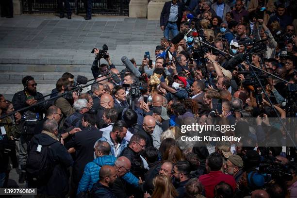 French President Emmanuel Macron is swarmed by media and local residents as he visits the Paris suburb of Saint-Denis as part of his campaign trail...