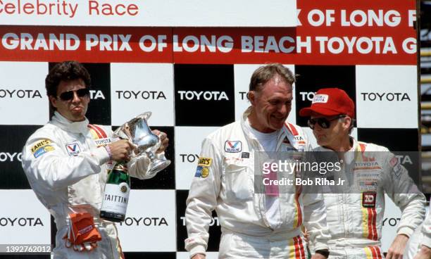 Actor/Racer Lorenzo Lamas is joined by racers Dan Gurney and Tony Swan during post Pro-Celebrity Race celebrations at the Toyota Long Beach Grand...
