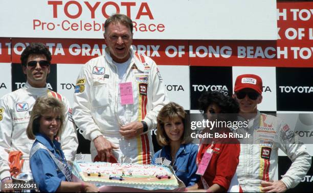 Racers Dan Gurney is surprised with a Birthday cake during post Pro-Celebrity Race celebrations with actor/driver Lorenzo Lamas and Tony Swan at the...