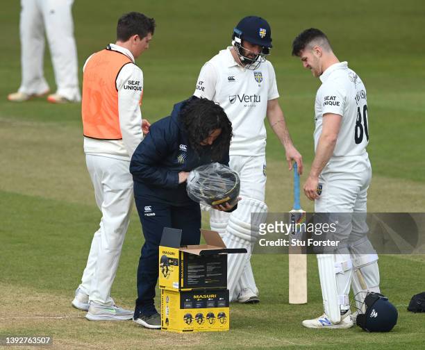 Durham batsman Liam Trevaskis has a new batting helmet brought out to him by physio Susan Dale after being hit on the head during day one of the LV=...