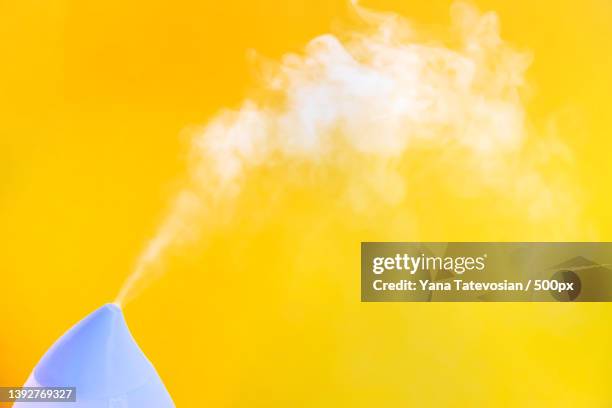 air humidifier on a yellow background selective focus - humidifier - fotografias e filmes do acervo